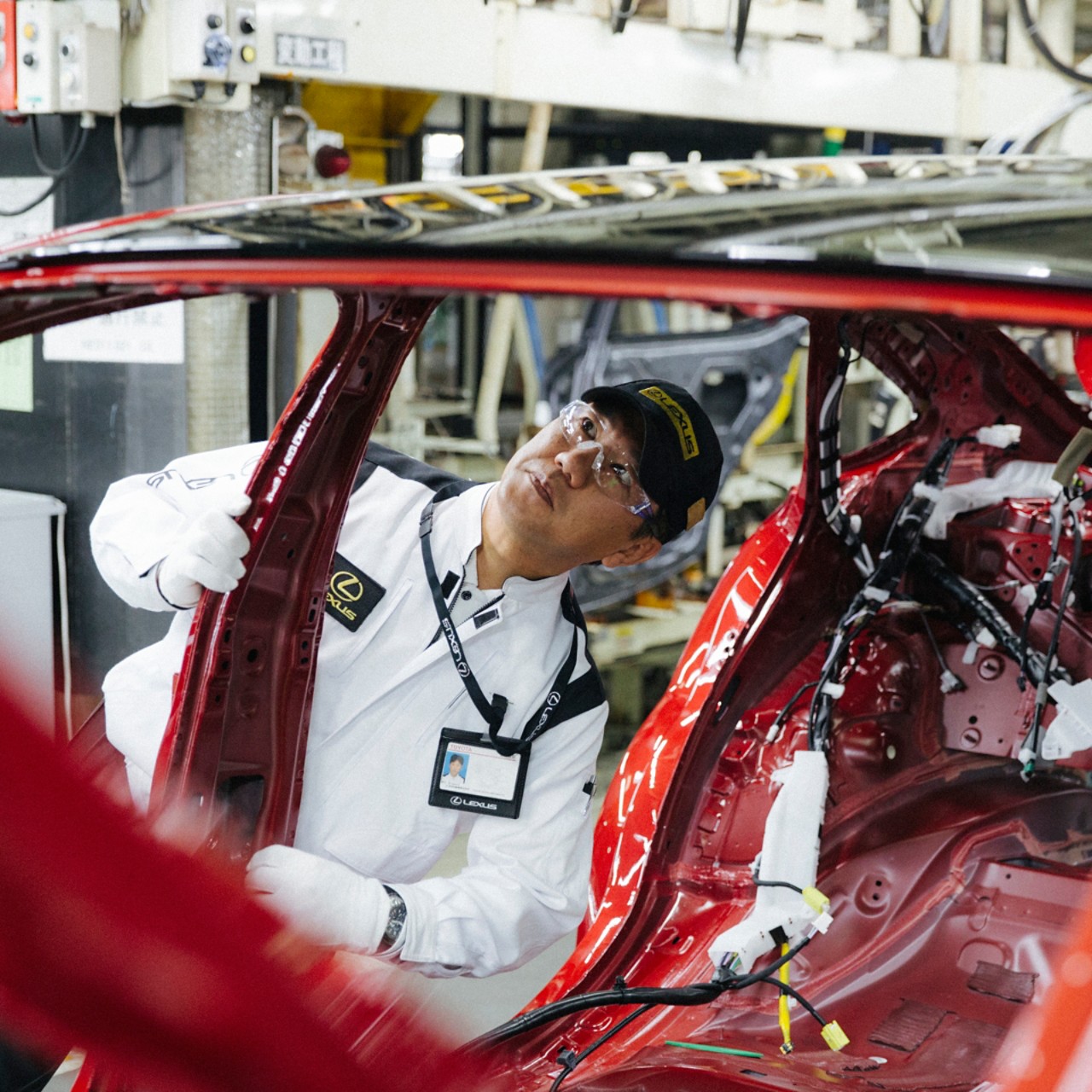 man looking inside a Lexus car