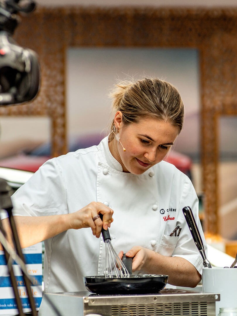 Emily Roux cooking in a kitchen