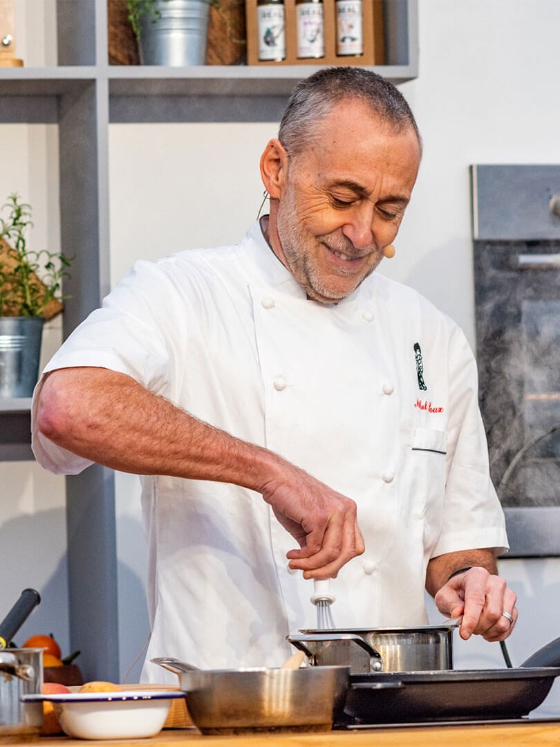Michel Roux Jr cooking in a kitchen