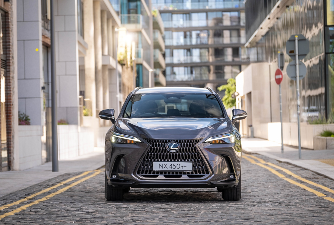 Lexus NX 450h+ driving.